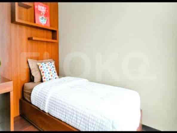 A simple bedroom with a single bed, shelves, and a desk.