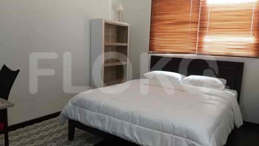 A bedroom with a bed, bookshelf, and blinds.