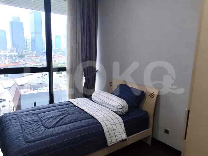 Bedroom with a single bed and a large window.
