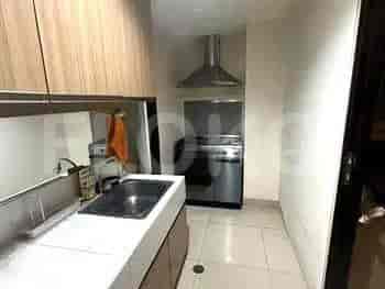 A kitchen with a sink and a stainless steel range hood.