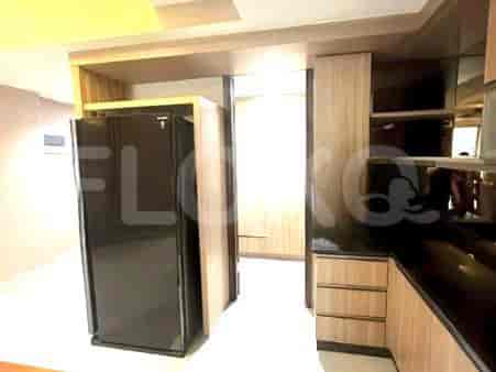 A kitchen with cabinets, refrigerator, and drawers.