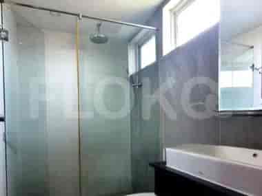 A modern bathroom with a glass-enclosed shower, a vanity, and a rain shower.