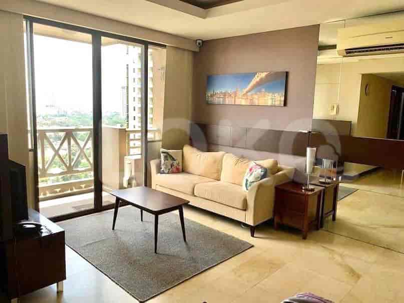 A well-lit living room with a sofa, coffee table, and access to a balcony.