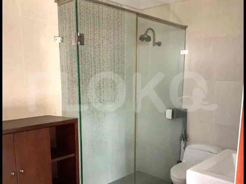 A modern bathroom with a glass shower enclosure and a sink.