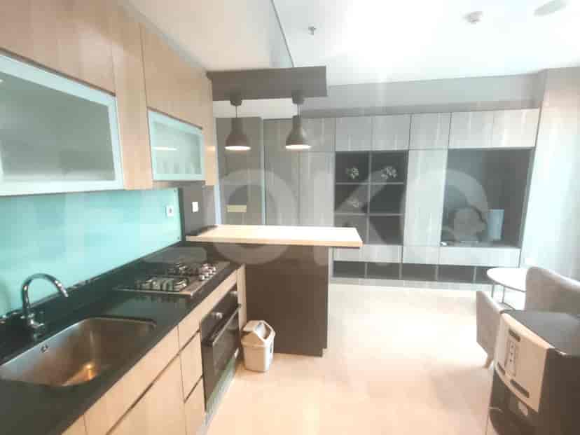 Modern kitchen with cabinets, countertop, and bar.
