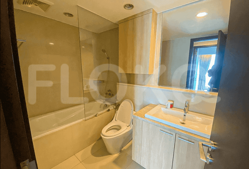A modern bathroom with a bathtub, shower, and vanity.