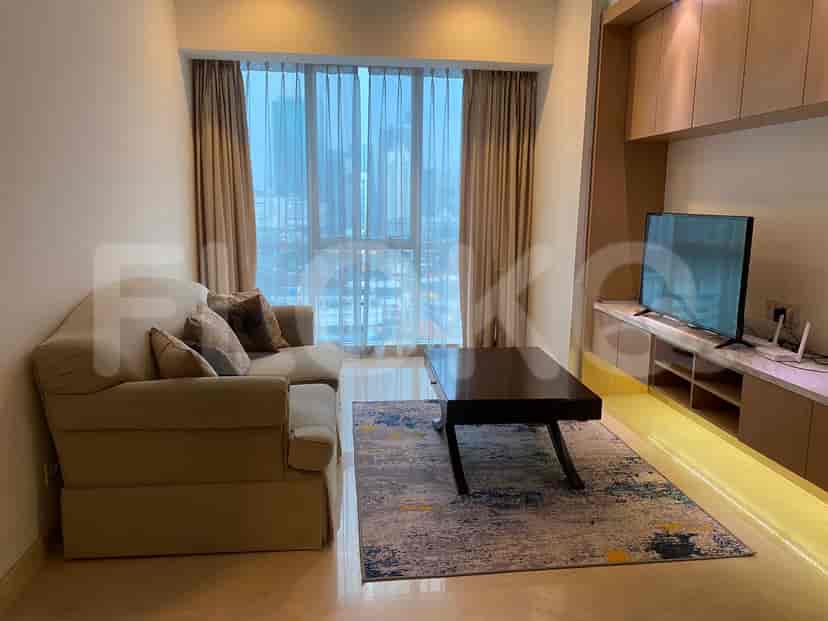 Living room with a sofa, TV, and a large window.