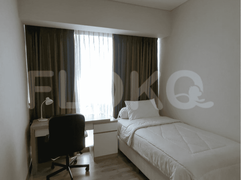 Bedroom with a single bed, desk, and large windows.