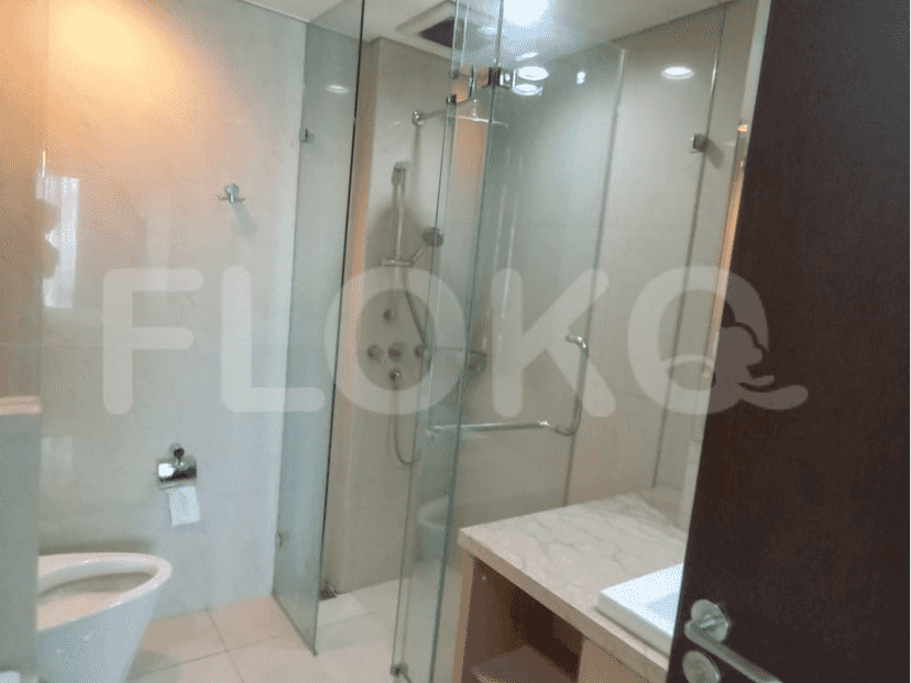 Modern bathroom with a glass shower and a white toilet.
