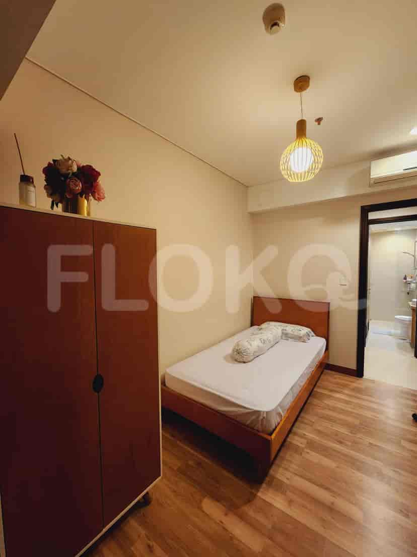 A cozy bedroom featuring a bed, wardrobe, and a warm, inviting ambiance.