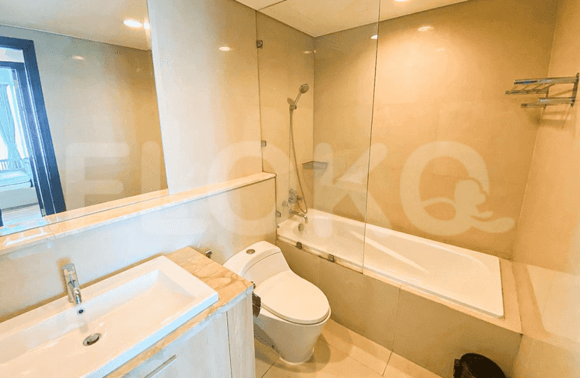 A modern bathroom with a bathtub and a glass shower enclosure.
