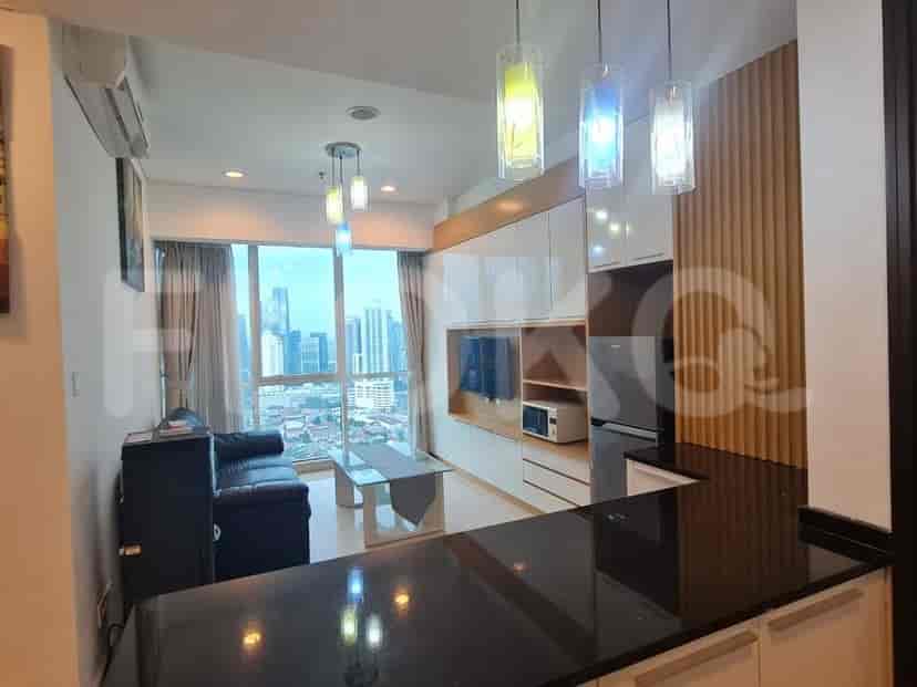Modern living area with built-in entertainment unit, city views, and pendant lighting.