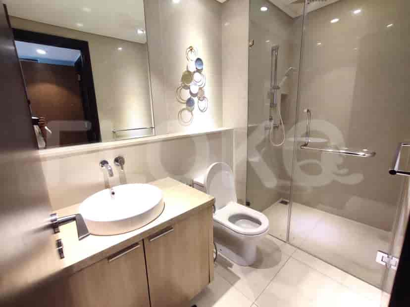 A modern bathroom with a walk-in shower and a vanity.