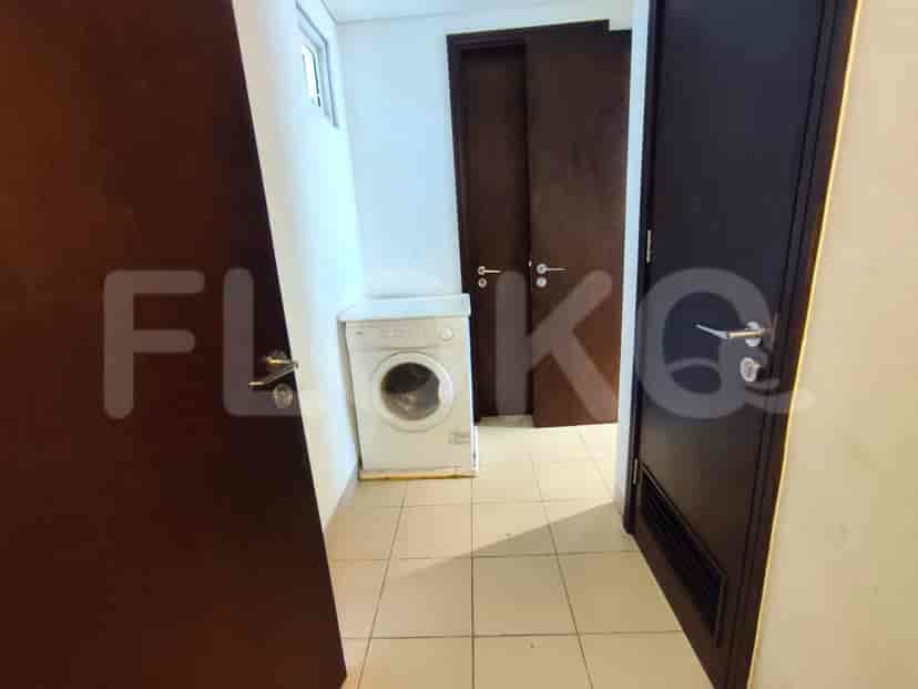 A laundry room with a washing machine and a door.