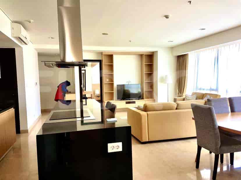 Living area with a view towards the dining area, kitchen, and access to other rooms.
