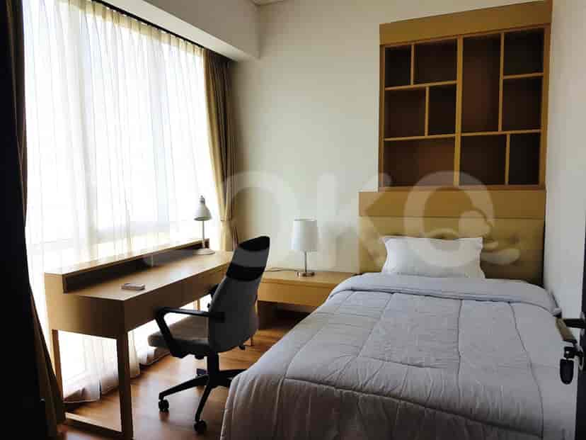 Bedroom with a bed, desk, and window.