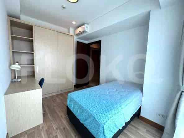 Another bedroom with a bed, desk, and closet.