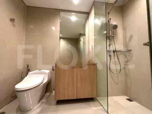 A modern bathroom with a shower, toilet, and vanity.