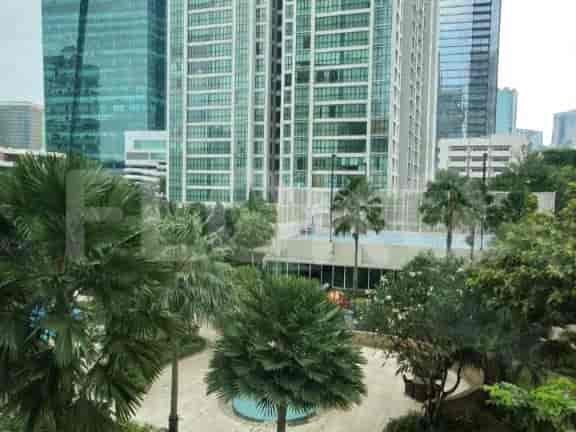 Exterior view from a window, showing buildings and trees.