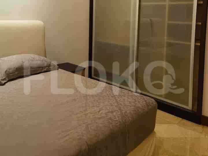 Bedroom with a bed, nightstand, and sliding door closet.