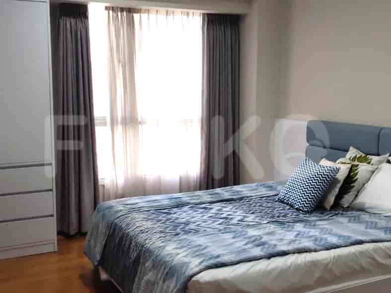 A bedroom with a double bed, curtains, and a closet.