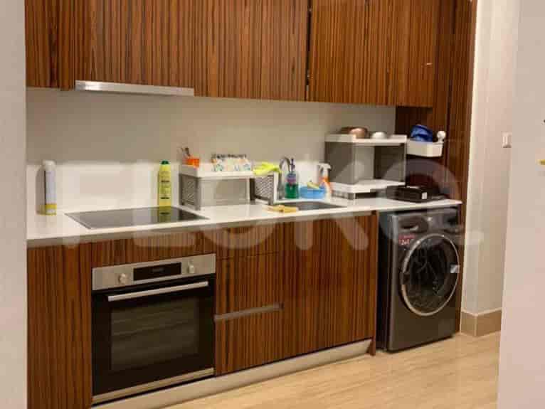 Modern kitchen with wooden cabinets and built-in appliances.