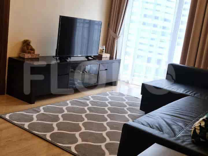 Living room with TV, dark furniture, and patterned rug.