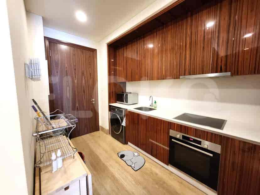 Modern kitchen with wooden cabinets, stainless steel appliances and white countertops.