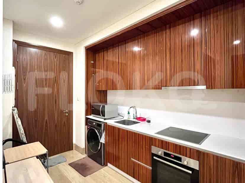 Modern kitchen with wooden cabinets and appliances.