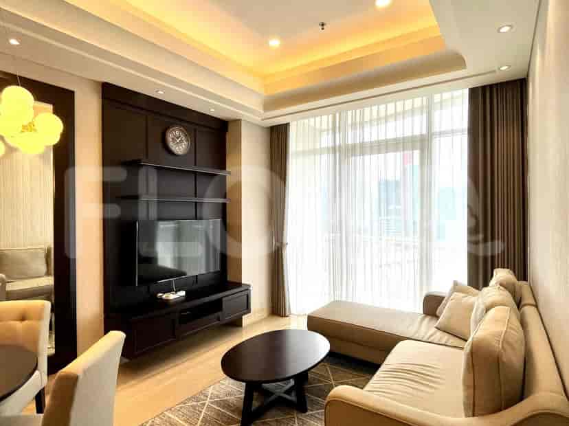 Elegant living room with dark wood entertainment center, a sectional sofa, and a large window.