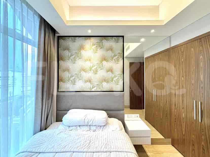 Elegant bedroom featuring a bed, wardrobe, and accent wall with decorative wallpaper.