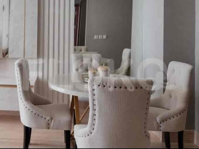 Elegant dining area with a round table and upholstered chairs.