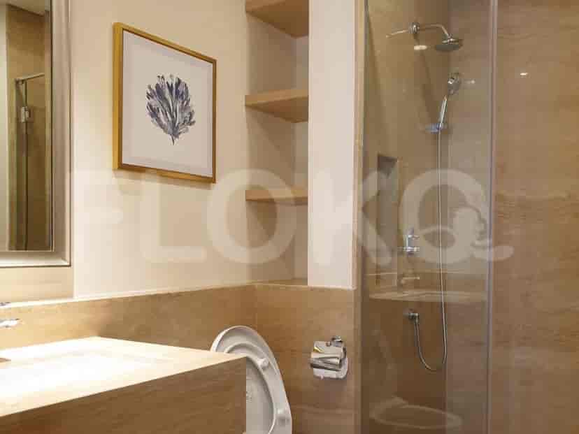 A bathroom with a shower, sink, and shelves.