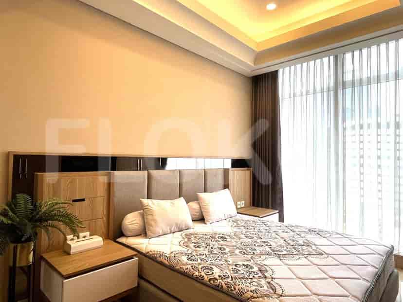 A spacious bedroom featuring a large bed, with a modern style.