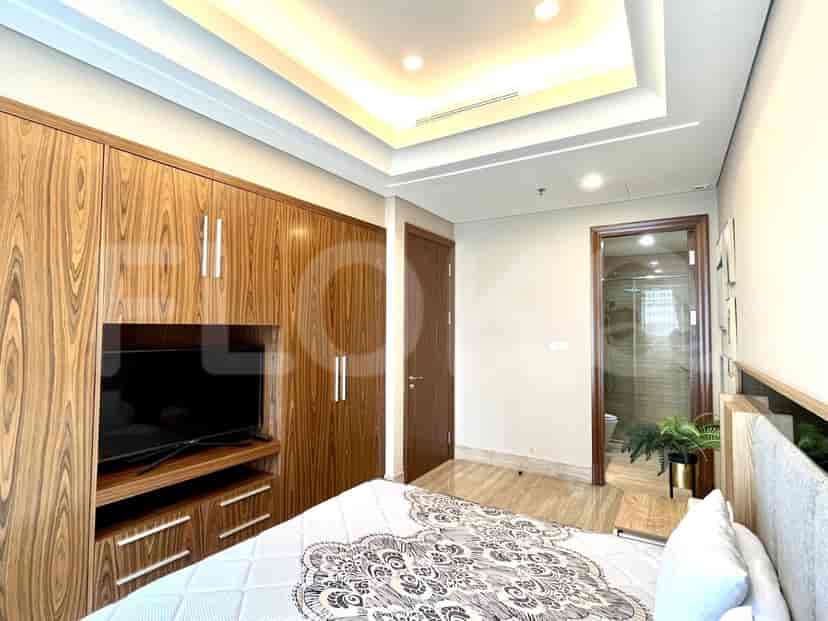 A bedroom with a bed, a large closet, and an adjacent bathroom.