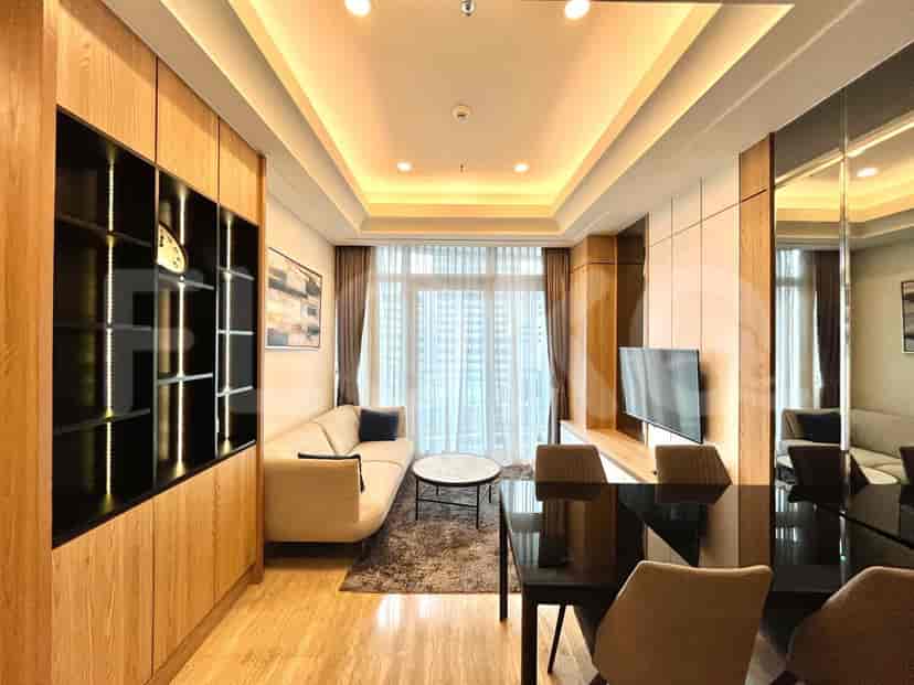 Spacious living room with a cream sofa, smart TV, and dining area.