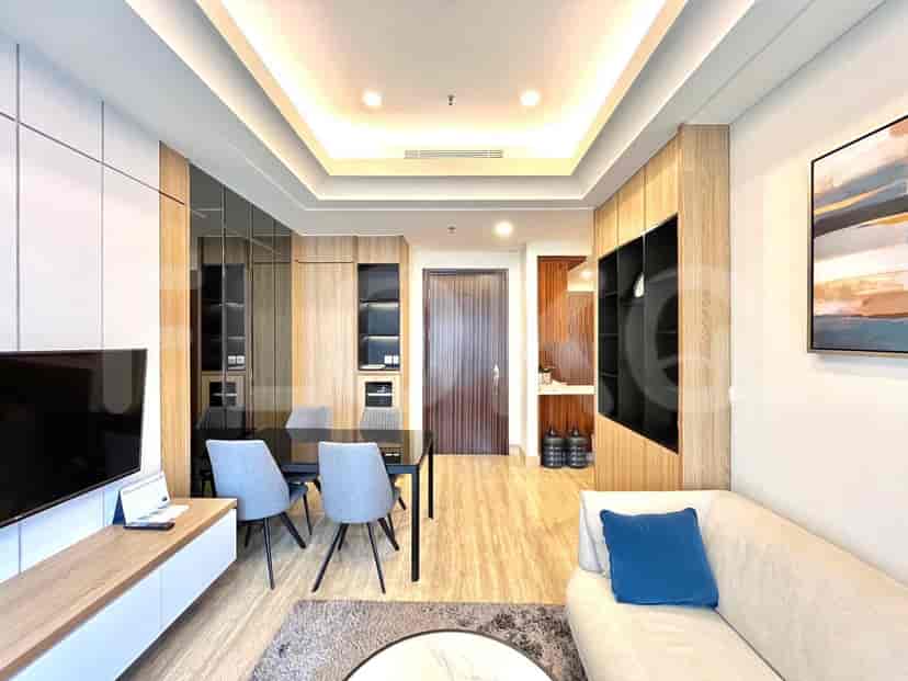 Living room with dining table, chairs, and door.