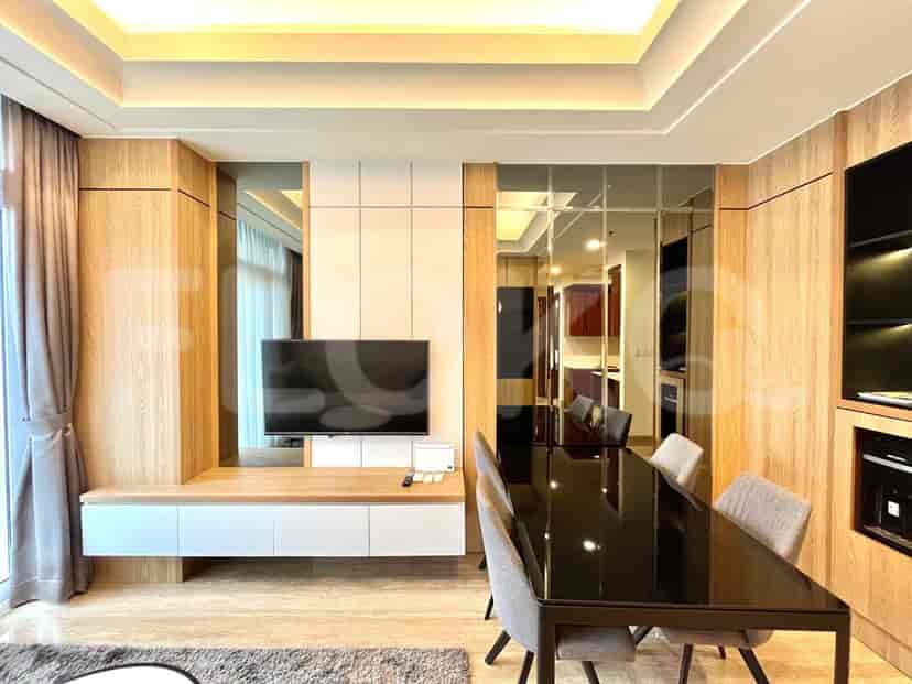 Modern living room with smart TV and dining area.