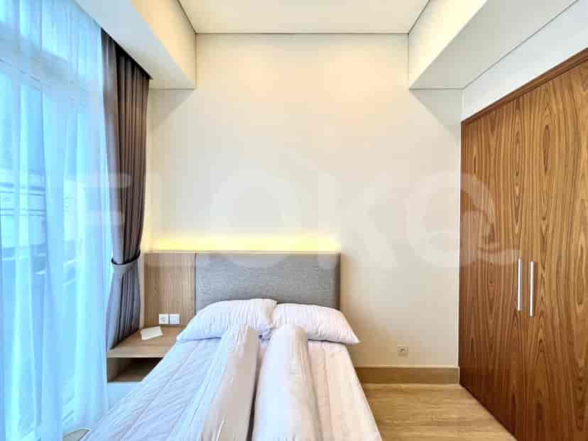 Bedroom with bed and wooden wardrobe.