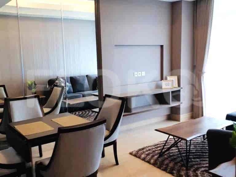 A bedroom with a bed, curtains, and neutral color scheme.