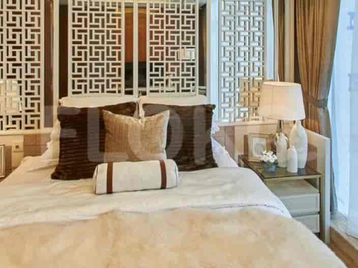 Elegant bedroom with a decorative headboard, neutral color scheme, and comfortable bedding.