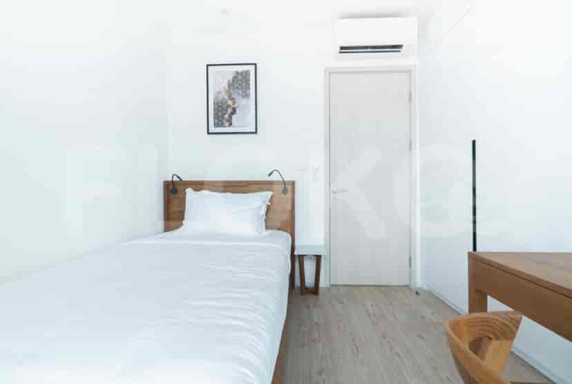 Small bedroom with a single bed and neutral color scheme.