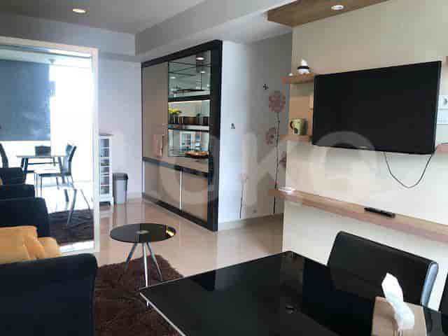 Modern living room with a black table, mirror, and built-in cabinet.
