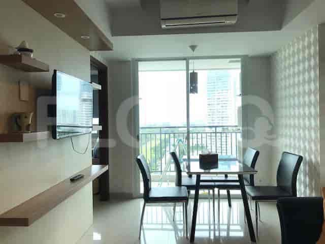 Dining area with a table, black chairs, and a window with a view.