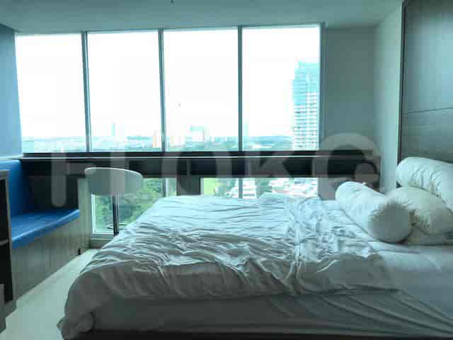 A spacious bedroom with a large bed and a city view.