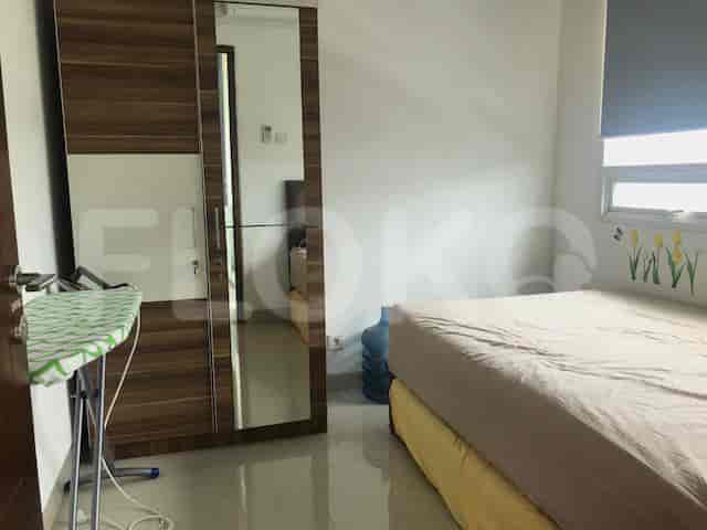 Bedroom with a bed, wardrobe, and ironing board.