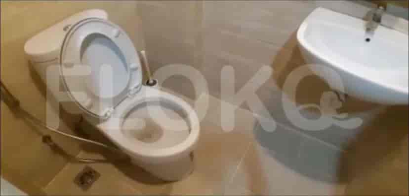 A small bathroom with a toilet and sink.