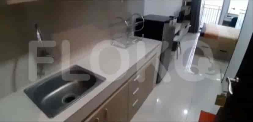 A closer view of the kitchen with sink and counter.