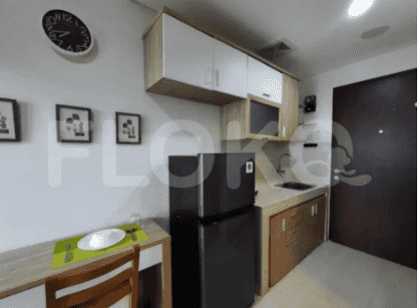 A studio apartment showcasing the kitchen and a dining area.