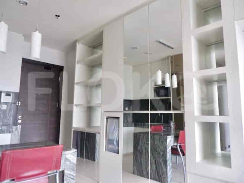 Kitchen with integrated appliances and white cabinets.